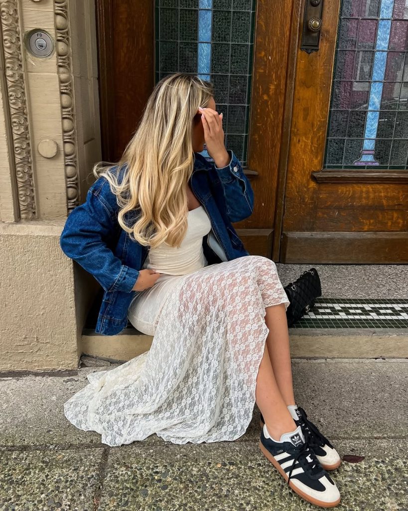  Casual spring outfit with dark denim oversized jacket, white top, white lace maxi skirt, navy and white retro sneakers and black quilted shoulder bag