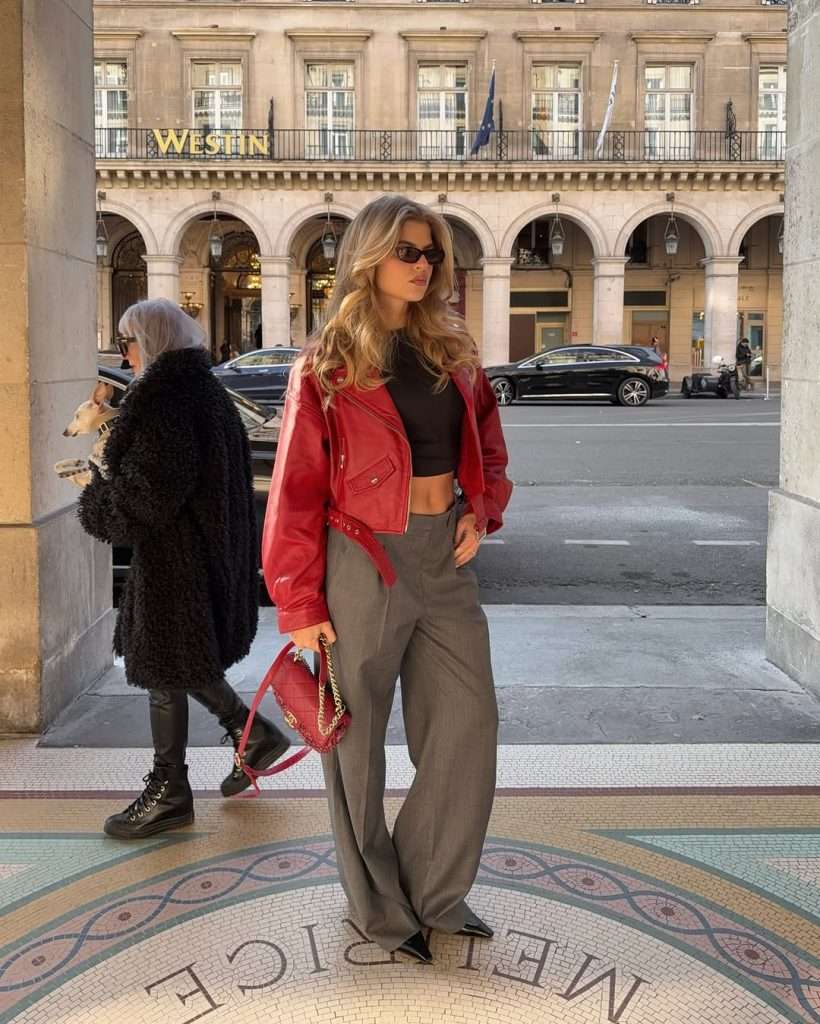 casual spring outfit with red leather jacket, black crop top, olive wide leg trousers, black pointed boots and red quilted shoulder bag