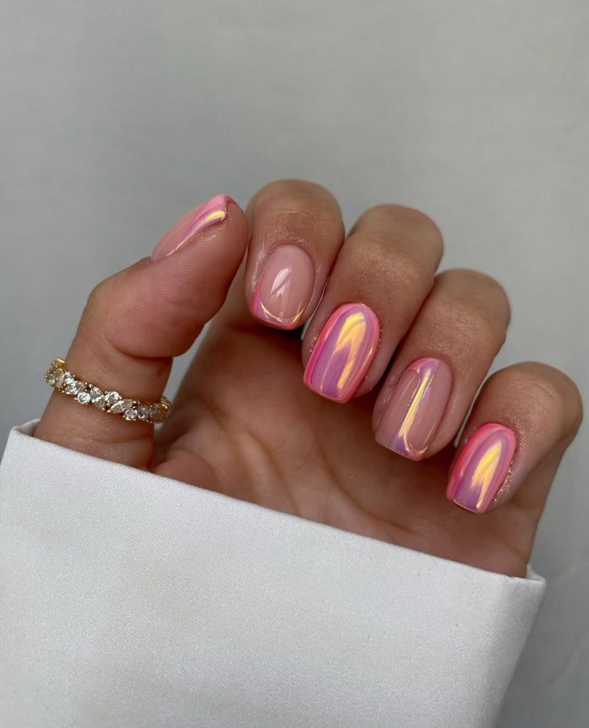  Short square nails with pink aurora chrome finish showing iridescent color shifts between pink and gold
