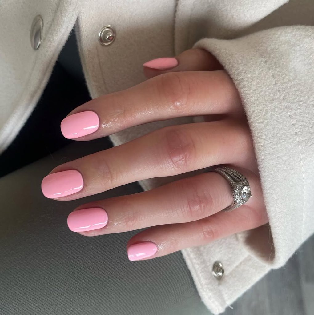 Short squoval nails with uniform glossy baby pink polish