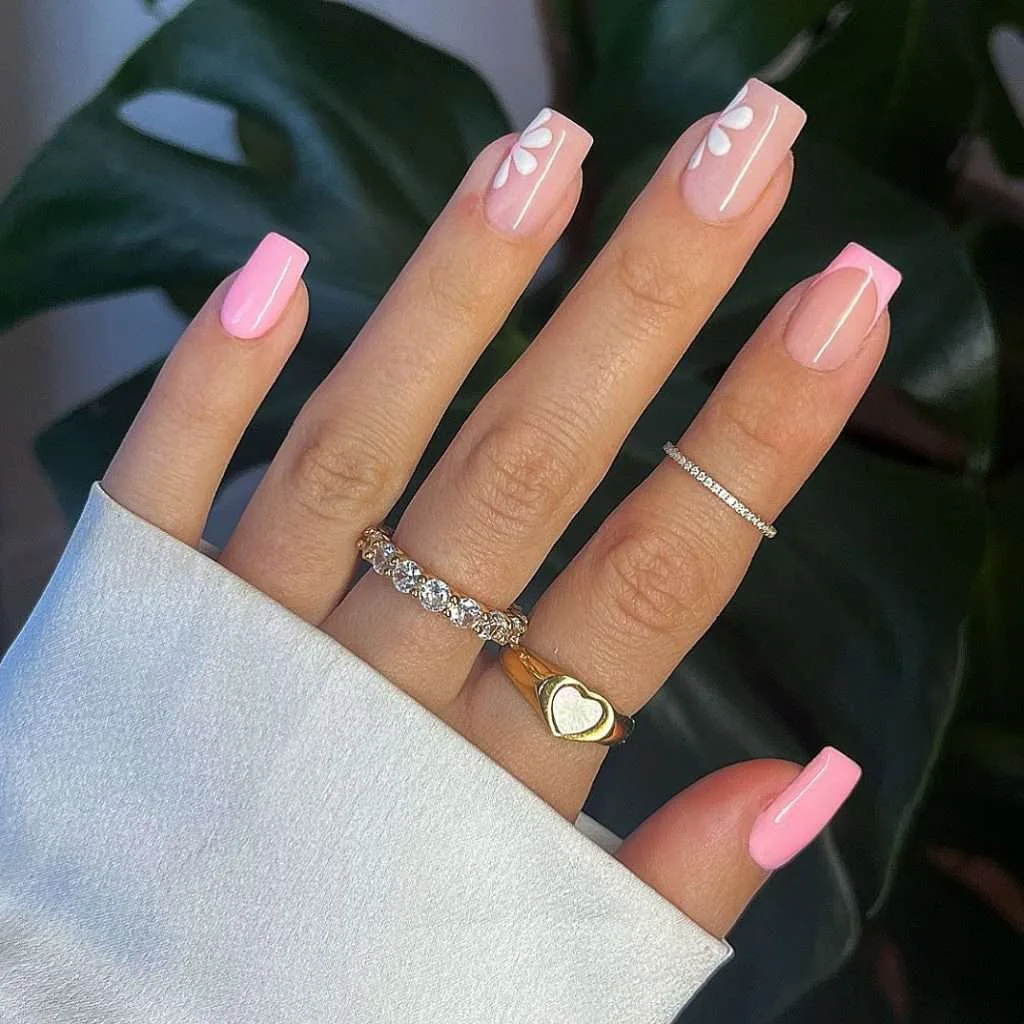 Medium square nails in mixed pink shades with white floral accents
