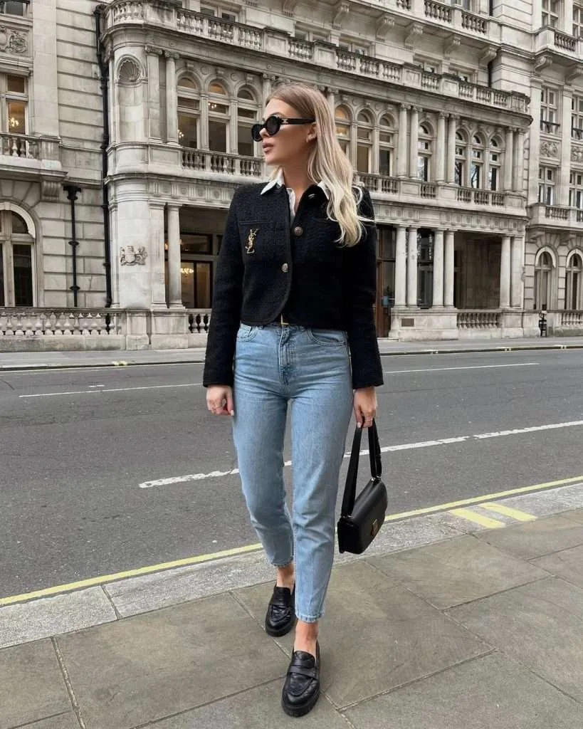 Classy spring outfit with black cropped boucle jacket, white collar shirt, light wash straight leg jeans, black loafers and structured black shoulder bag