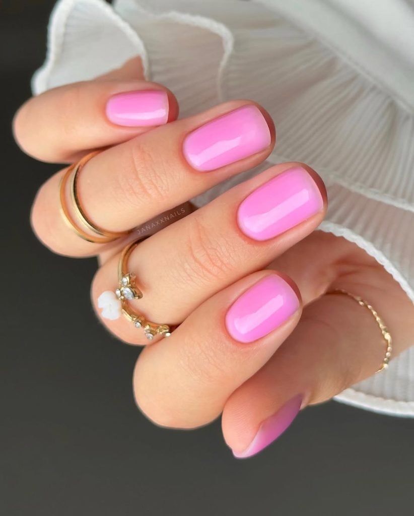 Short squoval nails with bright glossy bubblegum pink polish 