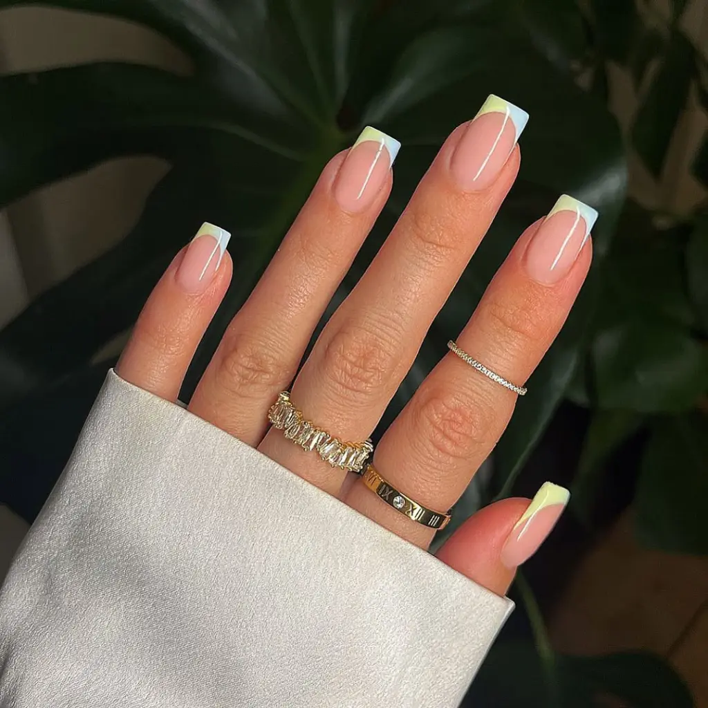 Square-shaped nude pink nails with French tips featuring a mint-blue gradient effect
