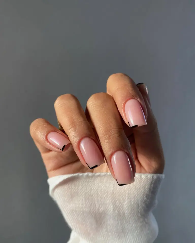 Minimalist square nude pink nails with thin black line accents on the tip corners only