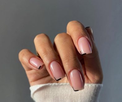 Minimalist square nude pink nails with thin black line accents on the tip corners only