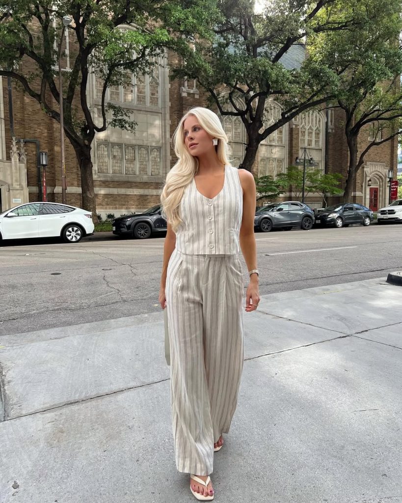 Elegant coordinated outfit with cream and grey striped linen tank top, matching straight-leg linen pants, white flip flops and minimal accessories