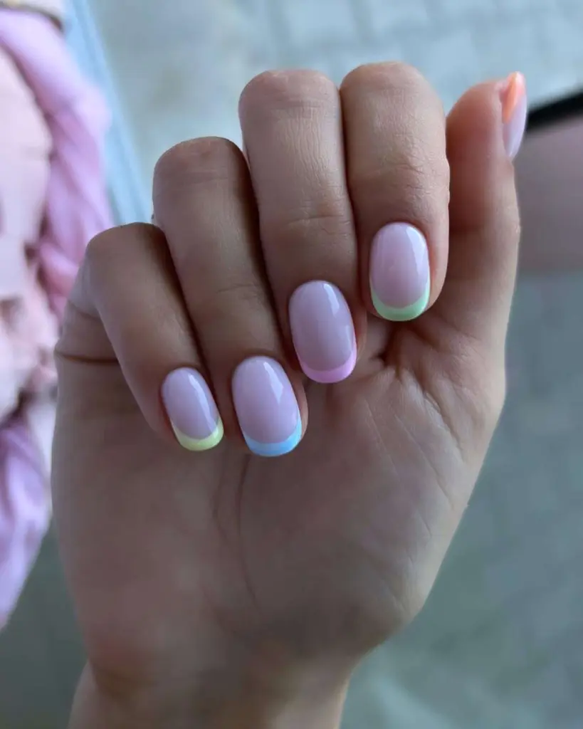  Short square nails with pink base and alternating pastel French tips in mint green, baby blue and light pink