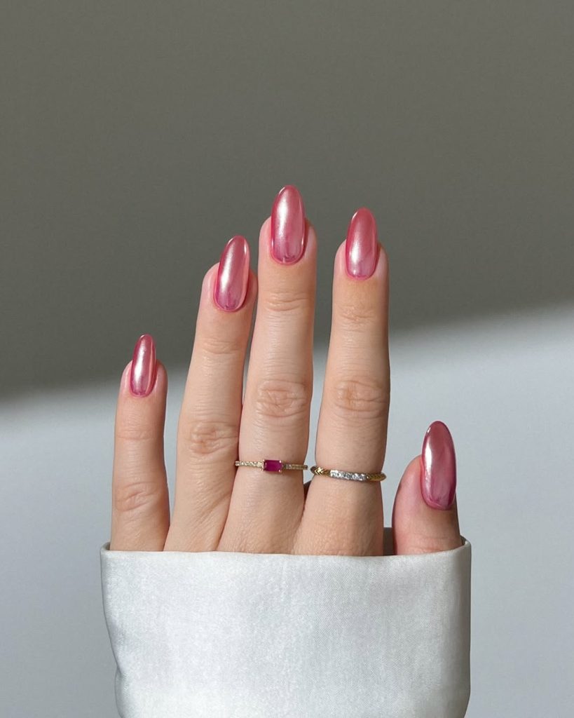 almond summer nails with glossy pink chrome finish and metallic shine effect