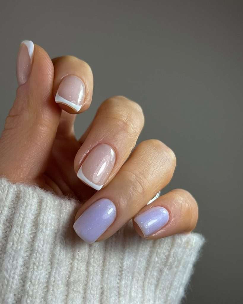 Short square nails with pink glitter French tips and solid lilac shimmer accent nails

