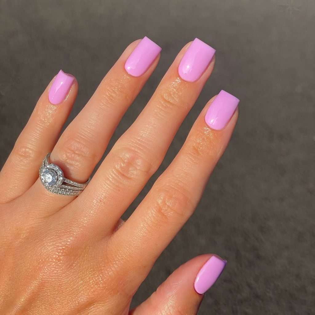  Short square nails in glossy bubblegum pink polish
