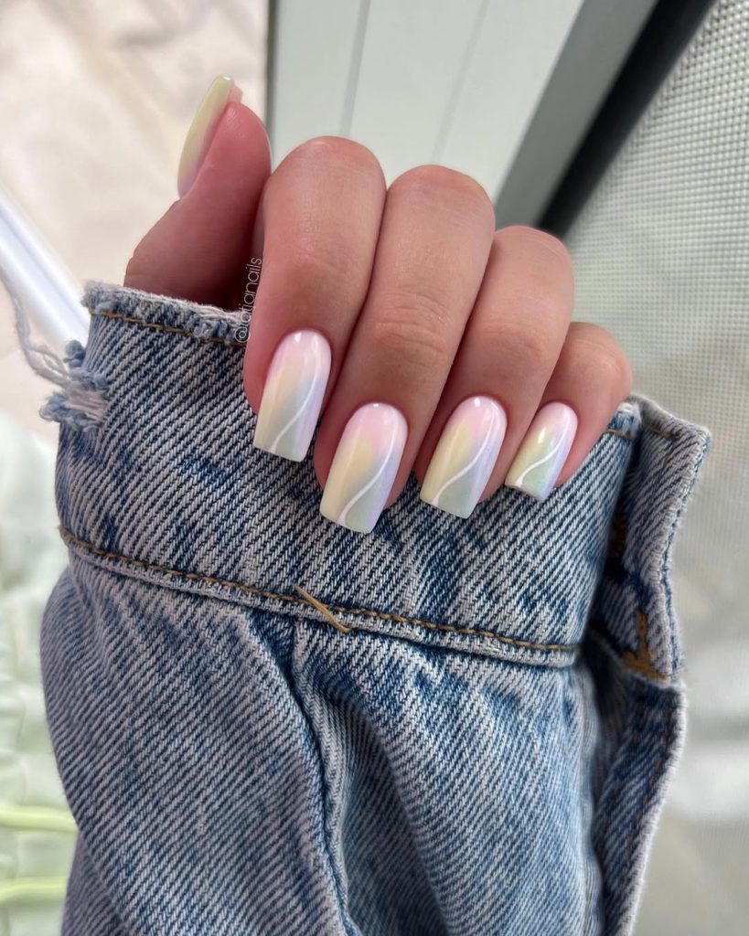 Long square summer nails with milky white base, pastel rainbow gradient, and curved white line design