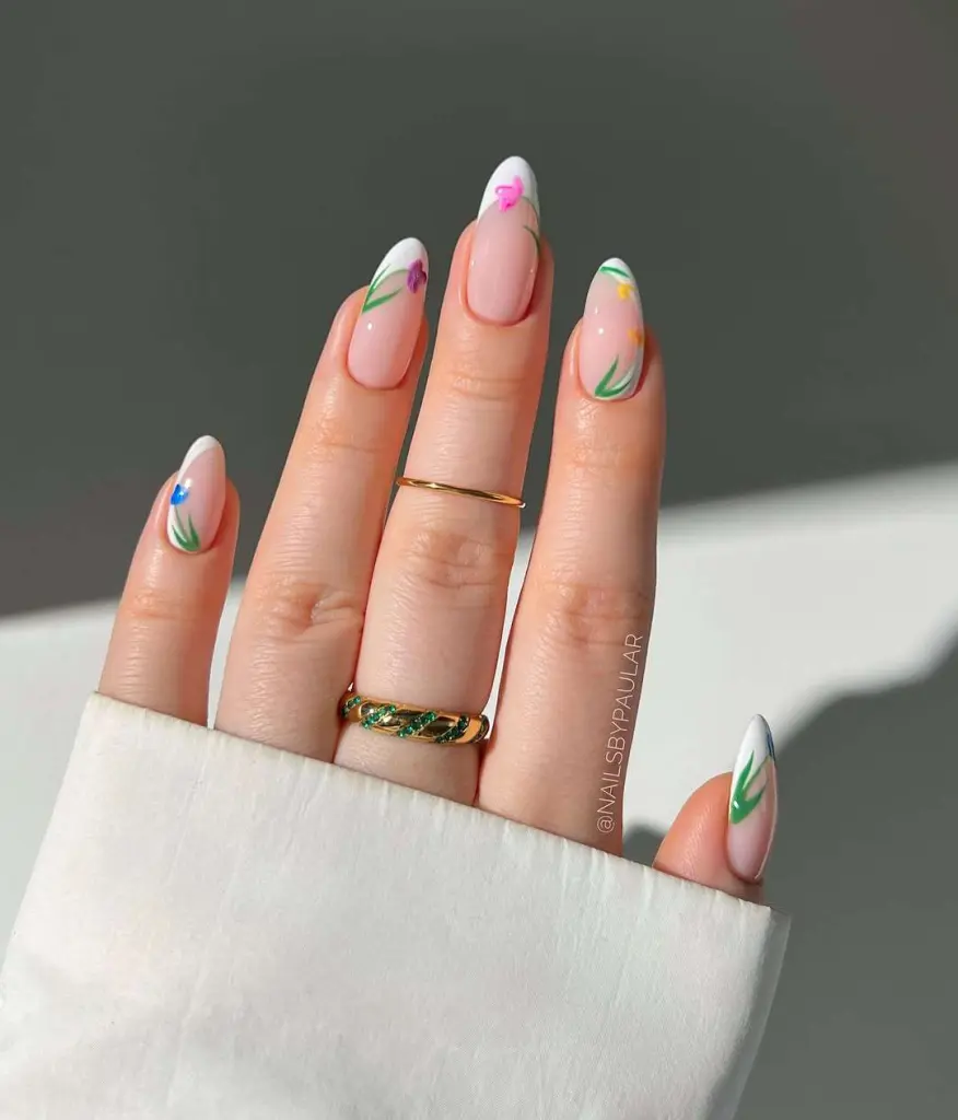 spring almond nails with pink base, white tips and multicolored tulip designs