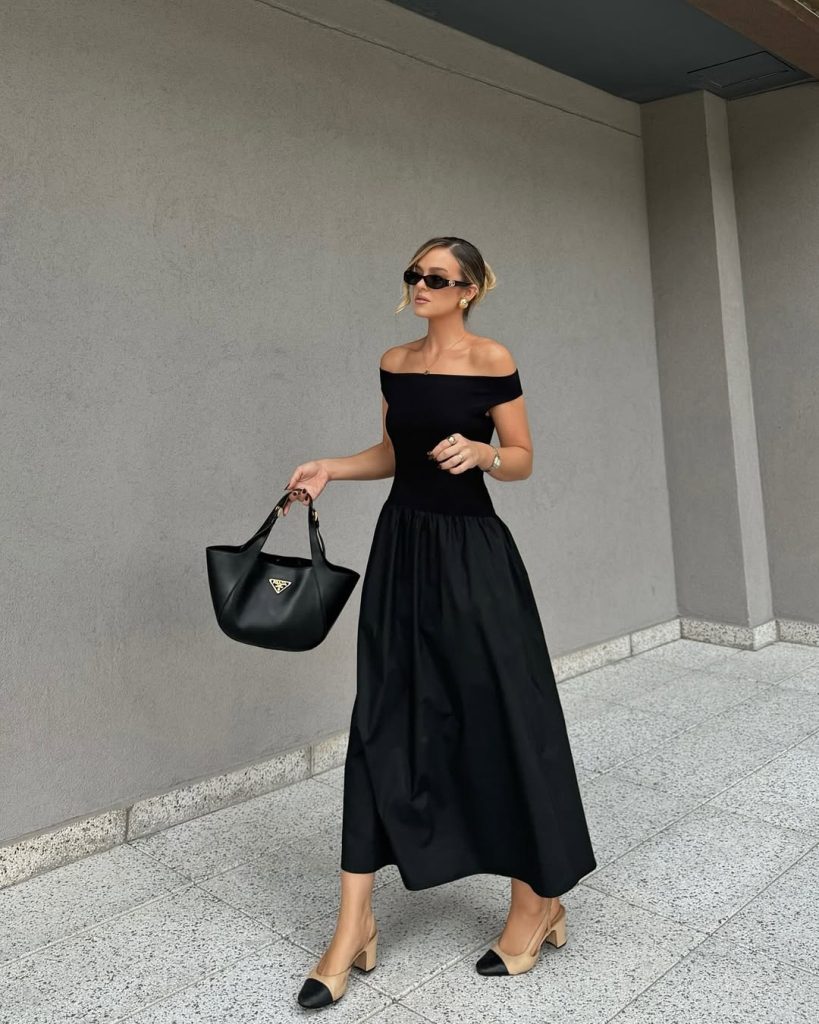 Summer outfit with black off-shoulder midi dress, beige and black cap-toe heels and black designer handbag

