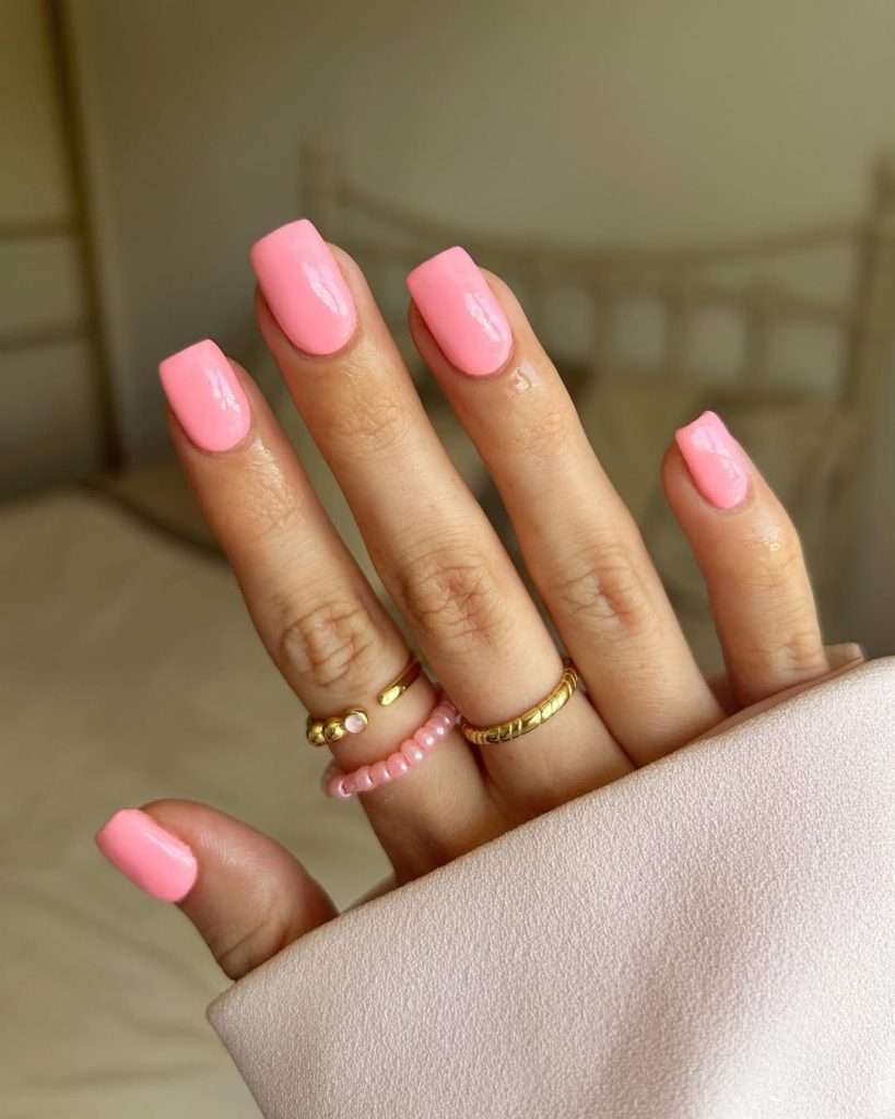 Short square nails with solid coral pink polish
