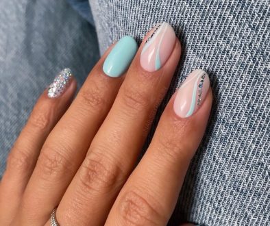 Short almond summer nails with mint green polish on some nails and transparent base with mint accent lines and holographic glitter details on others