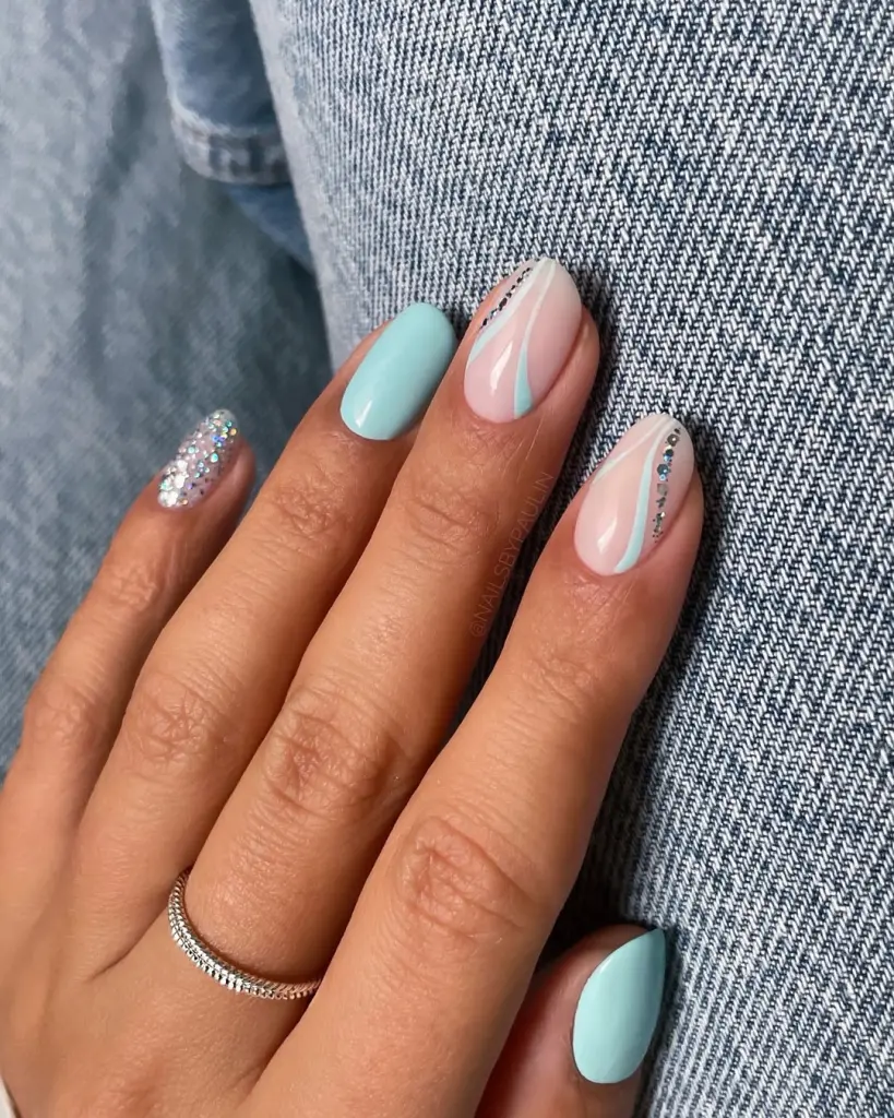 Short almond summer nails with mint green polish on some nails and transparent base with mint accent lines and holographic glitter details on others
