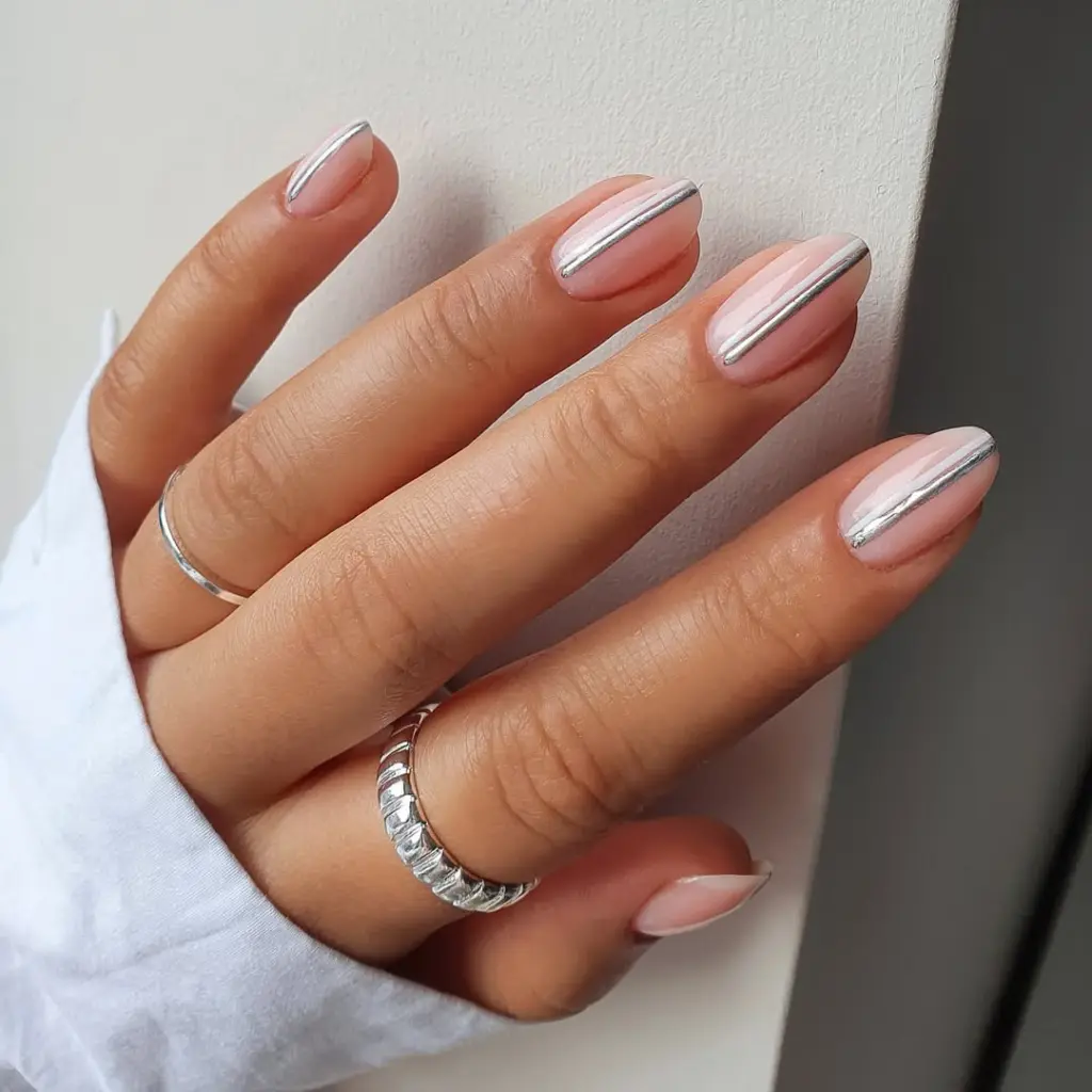 Short oval minimalist nails with sheer pink base and vertical silver chrome stripe with white line accent