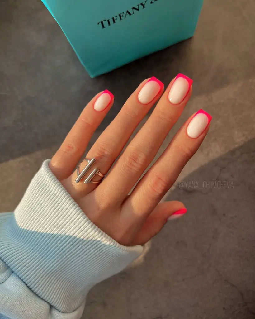 Short square summer nails with white base and hot pink French tips featuring one accent nail in matching solid hot pink polish