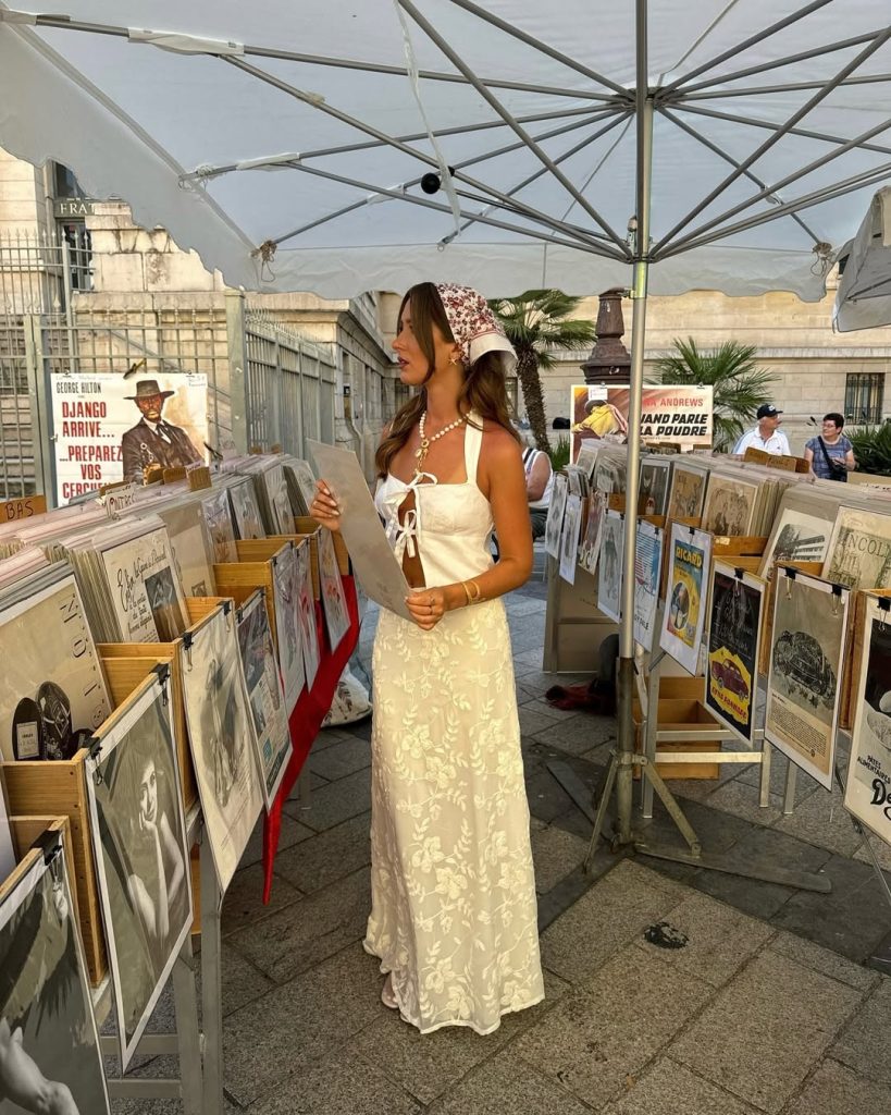 Romantic European vacation outfit with white tie-front linen top, cream embroidered maxi skirt and pearl statement necklace 