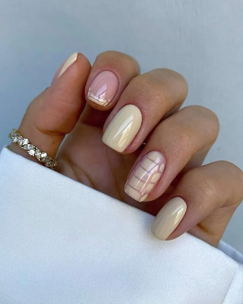 Short square nails with butter yellow polish and white daisy chain accent design