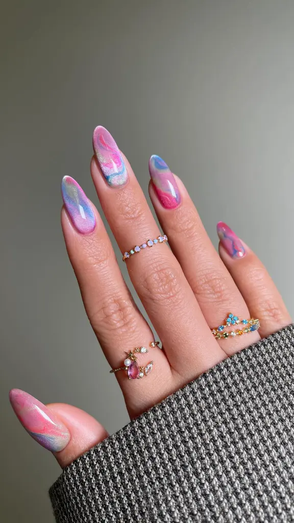 Almond summer nails with pink, blue and purple magnetic cat eye polish design with shimmer effect