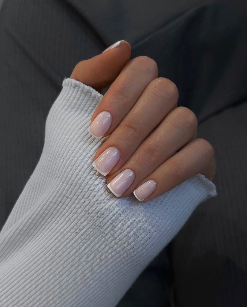 Short square nails with milky white base and thin white French tips
