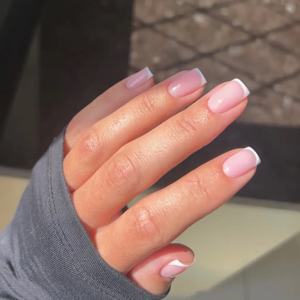 Short square minimalist nails with soft pink base and clean white French tips