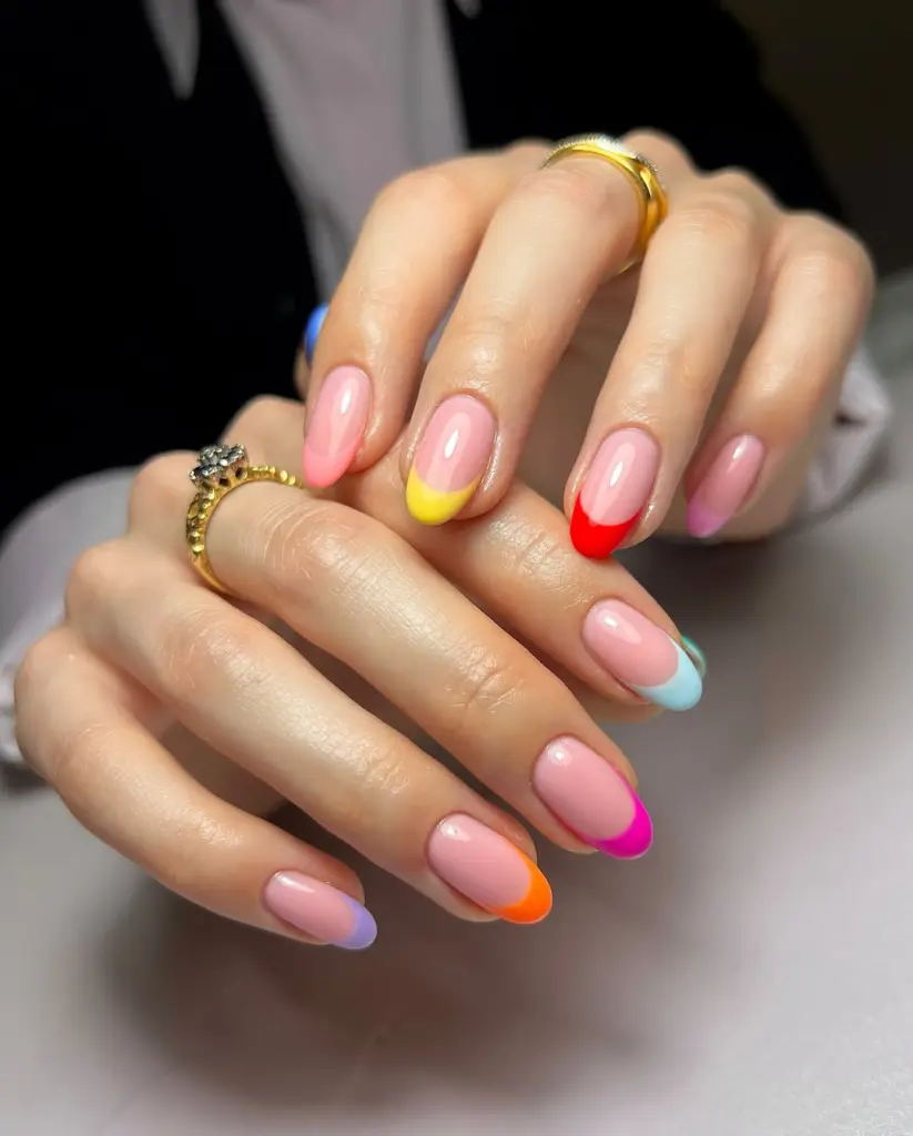  Oval summer nails with sheer pink base and multicolored French tips in red, yellow, orange, pink, purple and blue