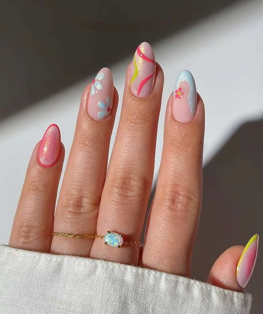 spring nails with shimmery pink base and abstract design in coral, yellow and blue with floral accents