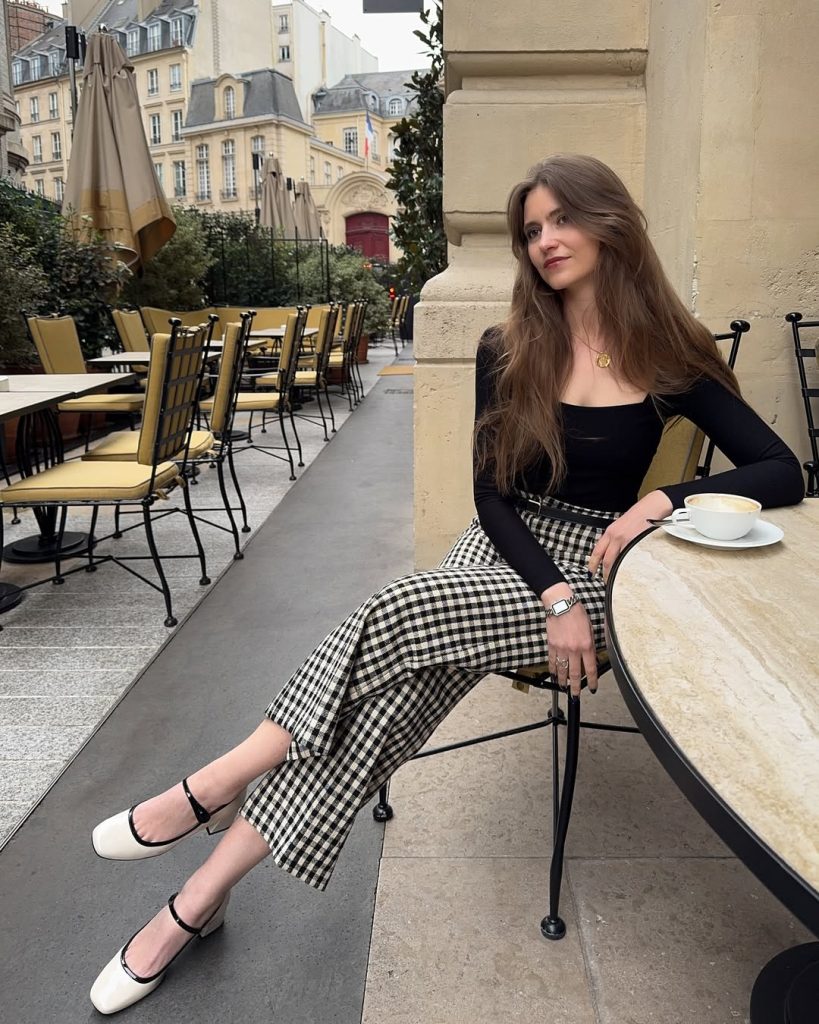 Classic European vacation outfit with black fitted top, black and white gingham wide-leg pants and Mary Jane heels
