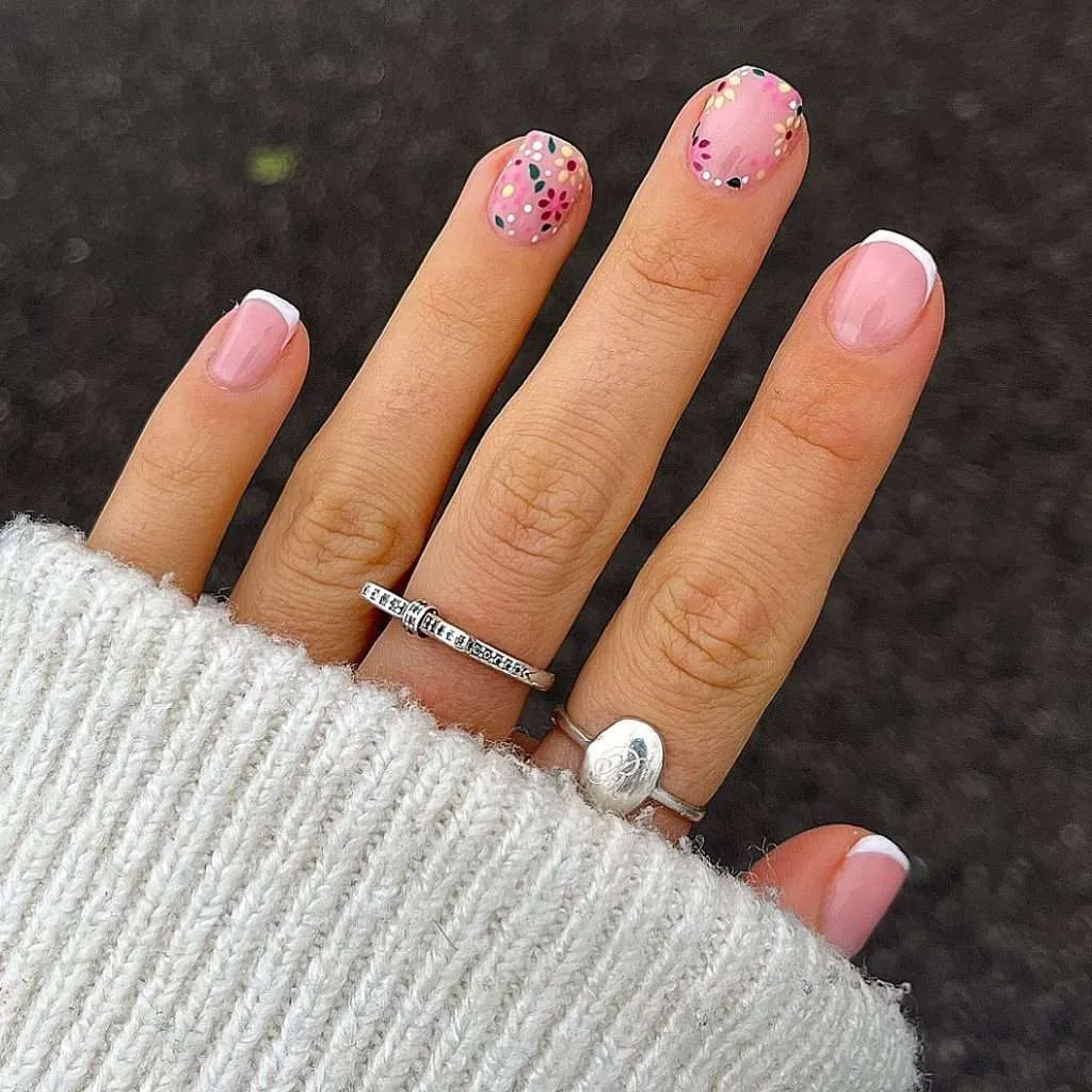 Short spring nails with French tips and pink floral accent design