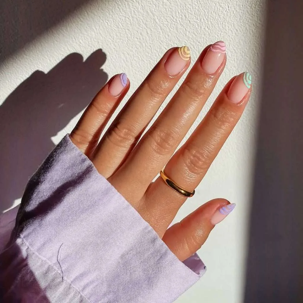 spring oval nails with pink base and pastel swirl designs on each tip
