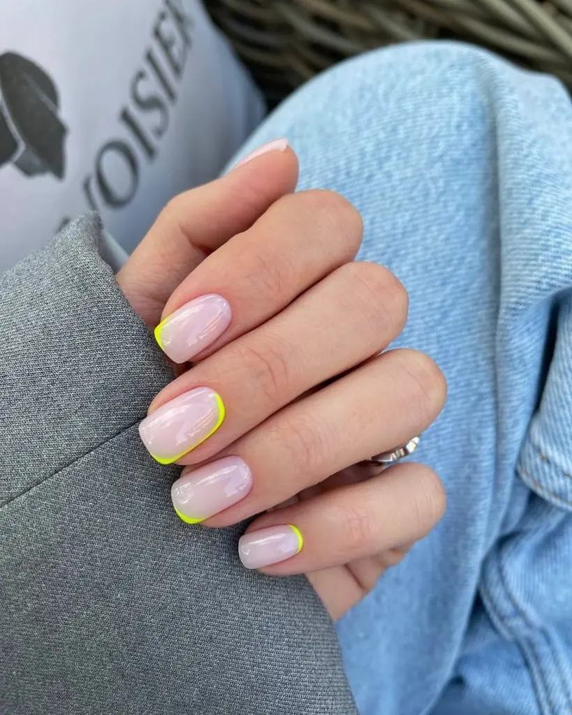 Short square summer nails with milky base and thin neon yellow French tip outlines