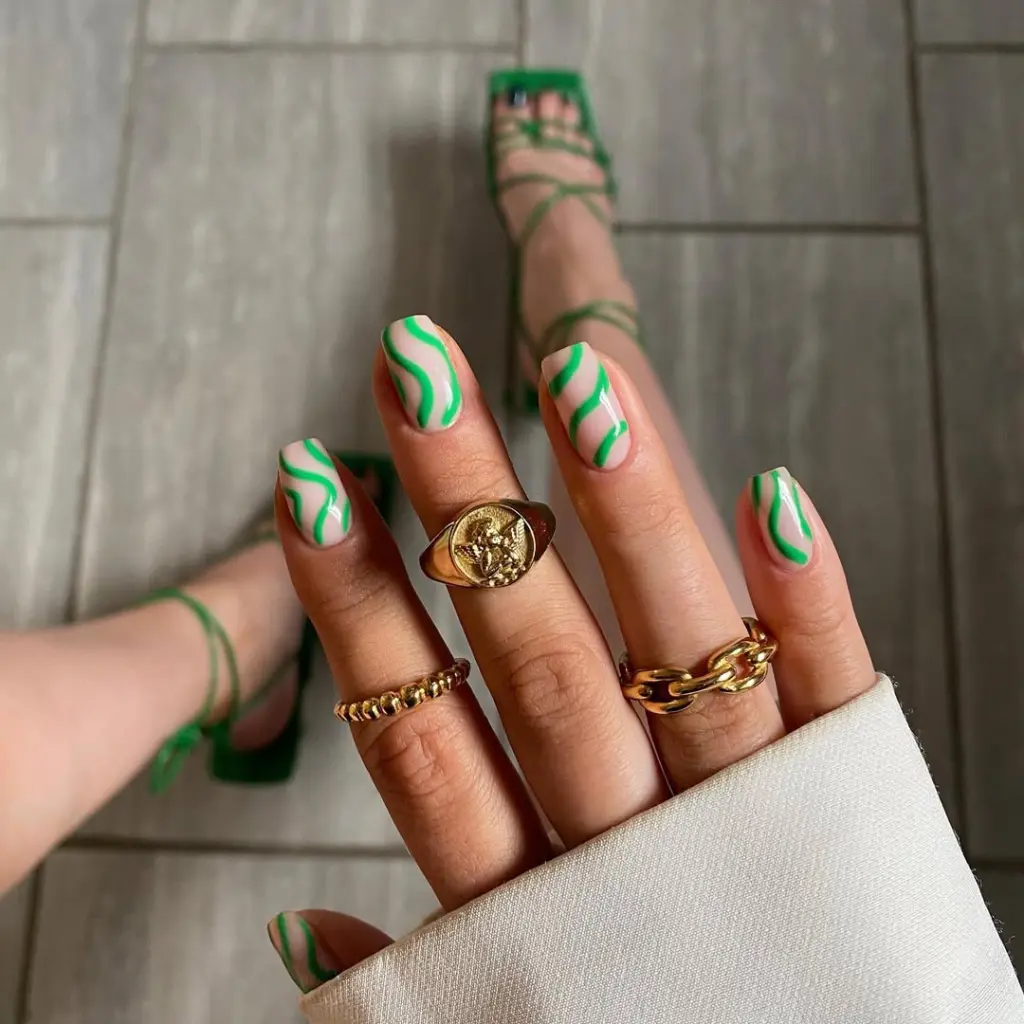 Square summer nails with nude base and neon green abstract wave pattern design

