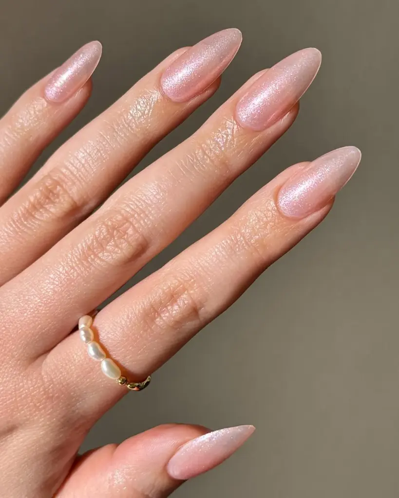 Almond shaped pink shimmer nails with pearlescent finish