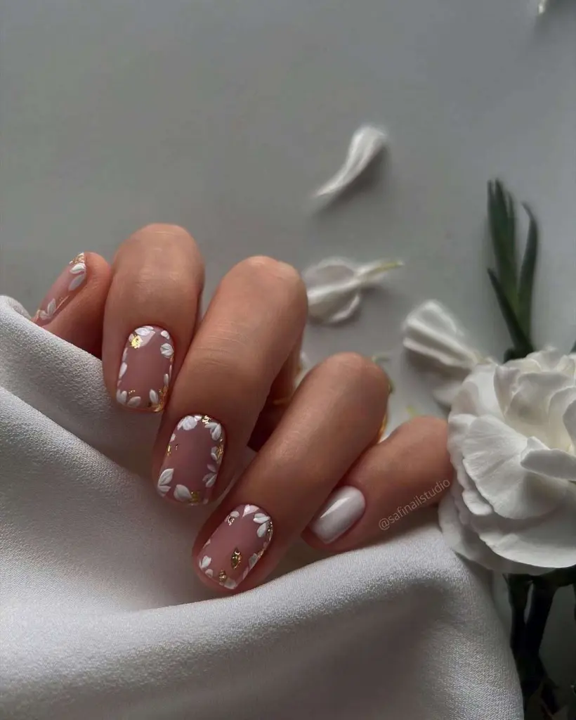 Short square classy mauve nails with white daisy pattern and gold foil accents plus one solid white nails for elegant spring manicure