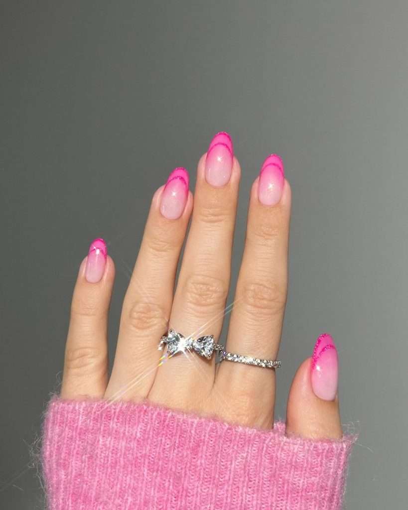 Almond shaped elegant sheer pink nails with bold hot pink French tips for spring manicure