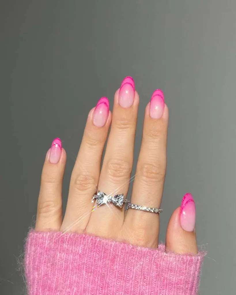 Almond shaped elegant sheer pink nails with bold hot pink French tips for spring manicure