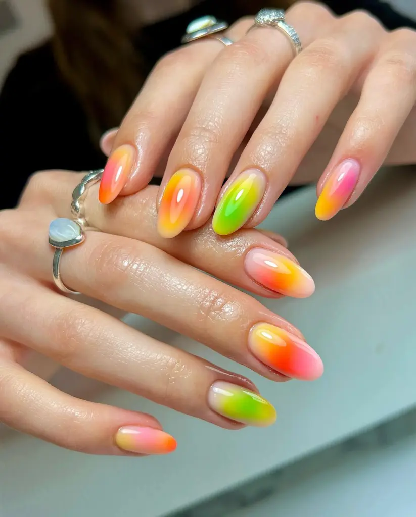 Almond summer nails with glossy neon ombré gradients in pink, orange, yellow and lime green colors
