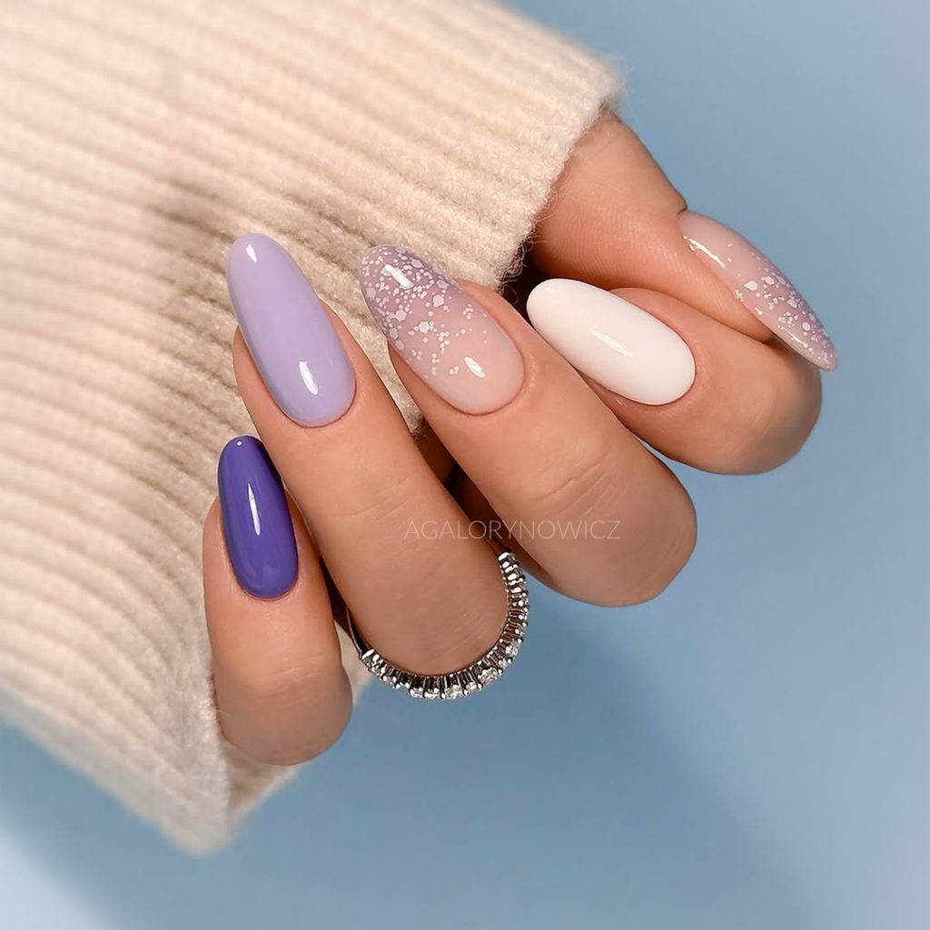 Almond graduation nails featuring purple, lavender, lilac and pink ombré with glitter gradient tips