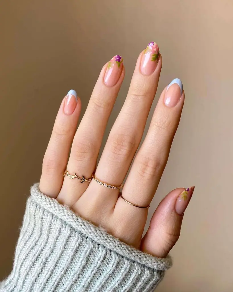 Almond shaped nails with French tips and pink floral accent design