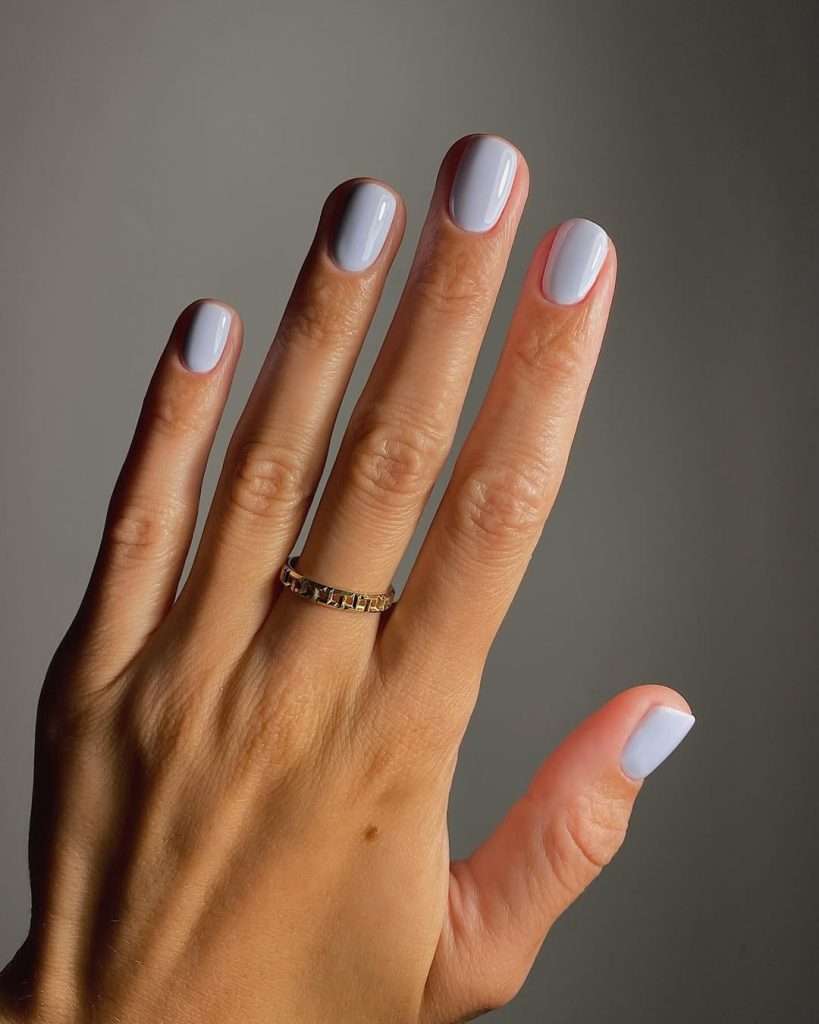Short square elegant nails in soft milky lavender white color for minimalist spring manicure