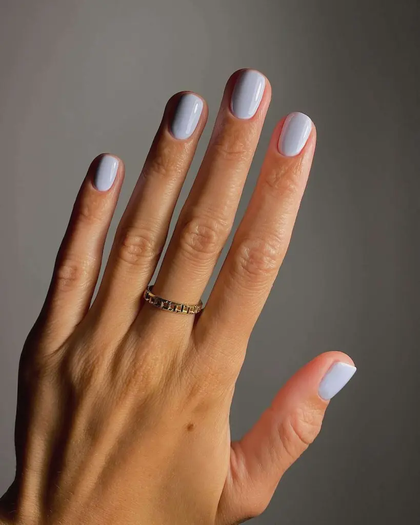 Short square elegant nails in soft milky lavender white color for minimalist spring manicure