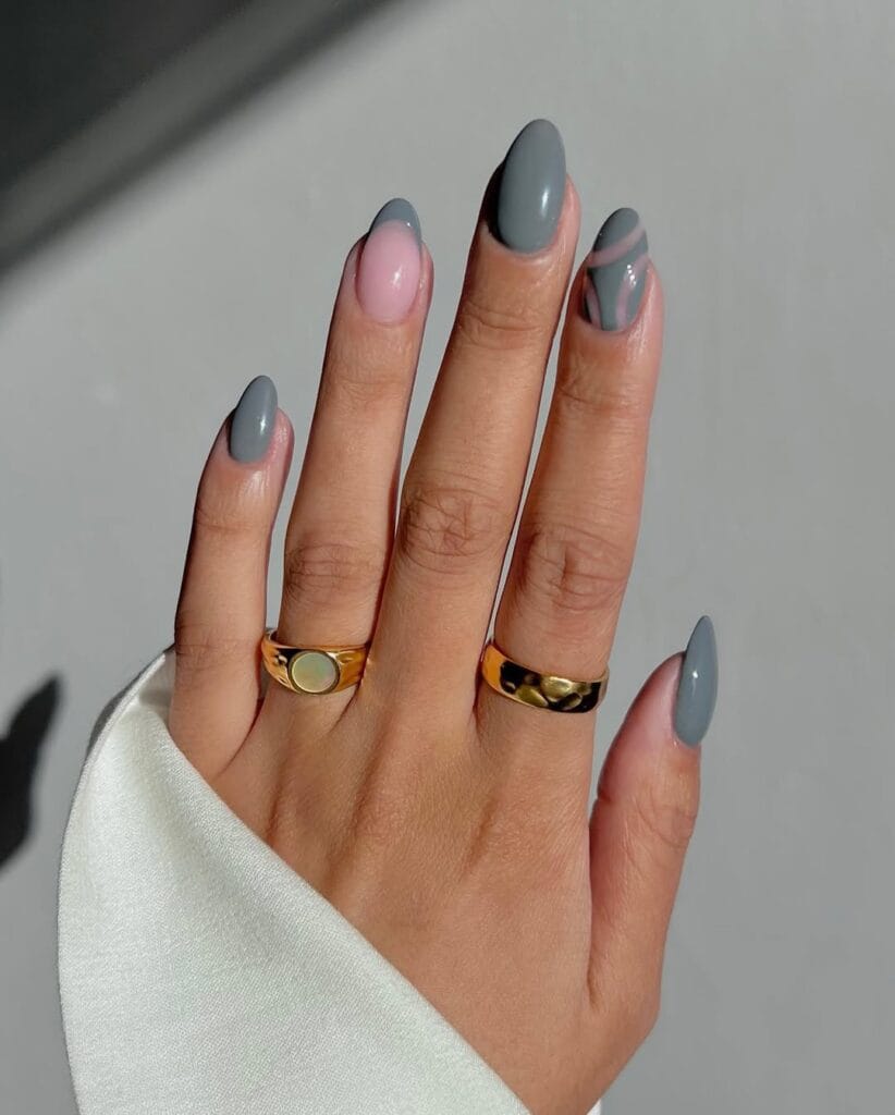 Almond minimalist nails with grey solid polish, one pink accent nail, and grey swirl detail