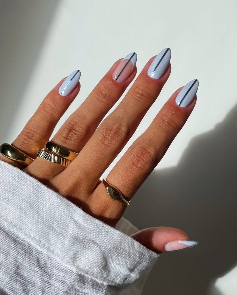 Almond minimalist nails with pale grey polish and single thin dark metallic chrome stripe down center of each nail