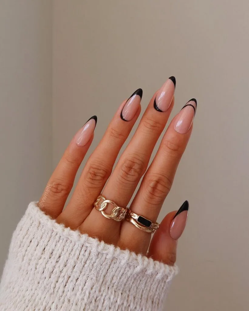 Almond minimalist nails with nude pink base and ultra-thin black curved French tip lines