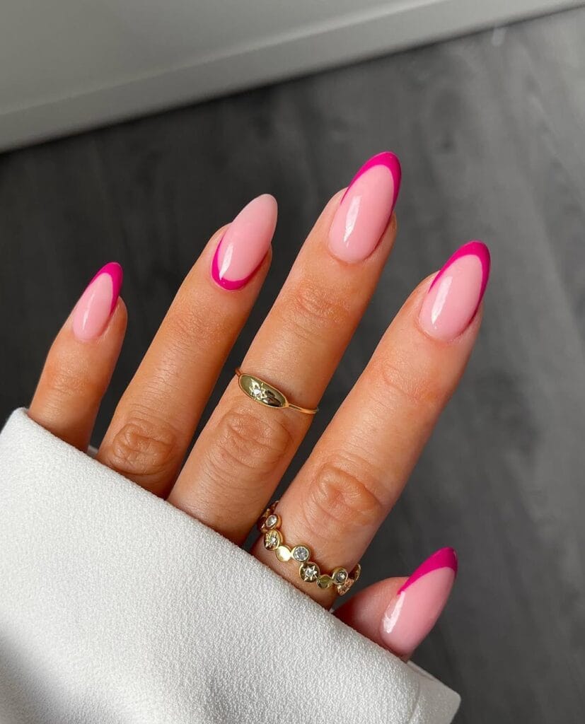 Almond minimalist nails with pale pink base and bright hot pink French tips