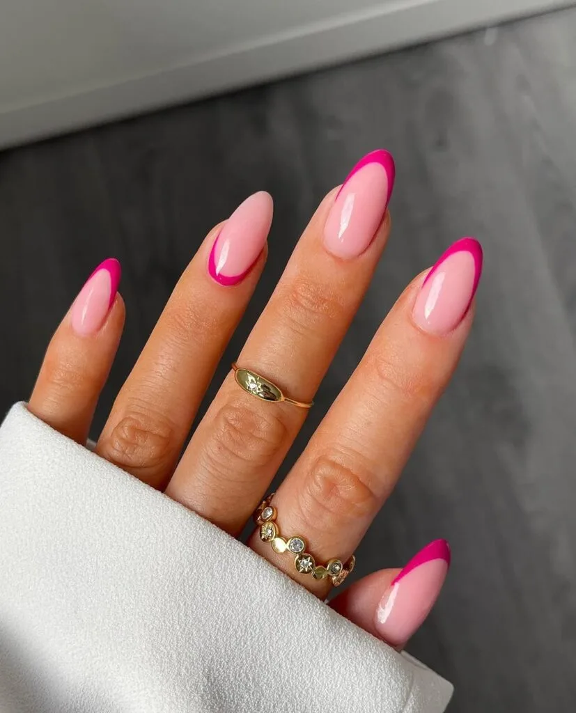 Almond minimalist nails with pale pink base and bright hot pink French tips