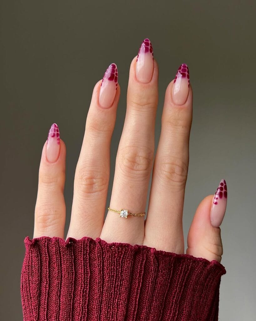 Almond minimalist nails with sheer pink base and burgundy leopard blooming pattern on tips